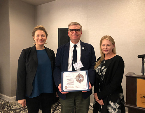 Receiving the certificate are Jolene Kijorski, Executive Vice President with Preservation Detroit, and Dawn Bilobran, who led the tour of downtown Detroit.