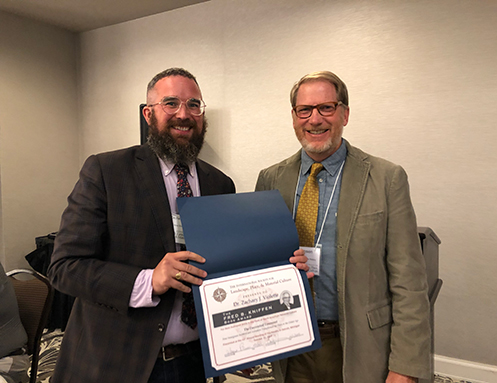 Dr. Violette receiving the 2019 Fred B. Kniffen Book Award